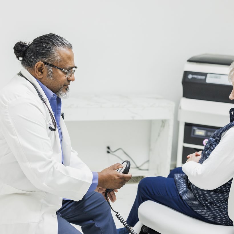 Dr. Vinod administering shockwave therapy to a patient